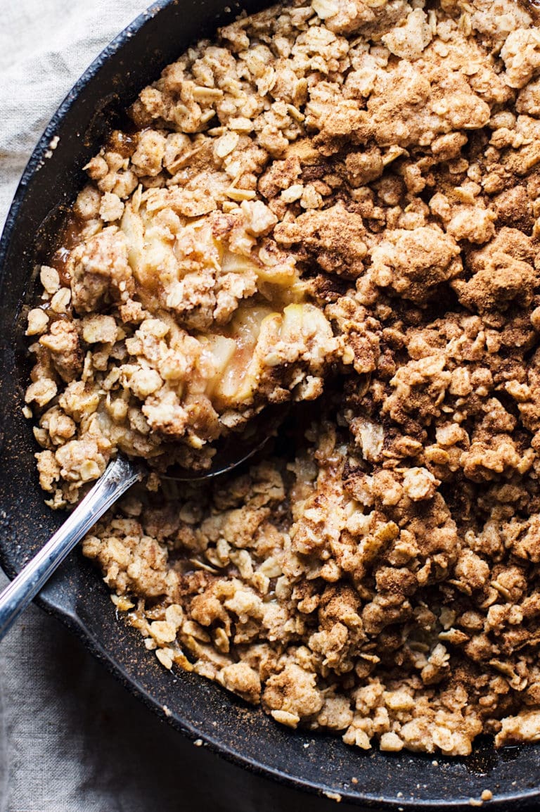 a close up of apple crumble with a spoon in it.