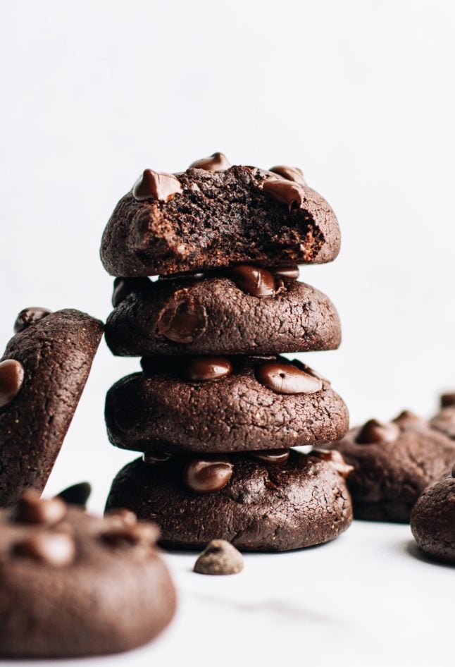 brownie cookies stacked on top of each other and one with a bite out of it.