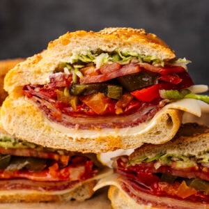 Slices of Italian sub stacked with a dark gray background.