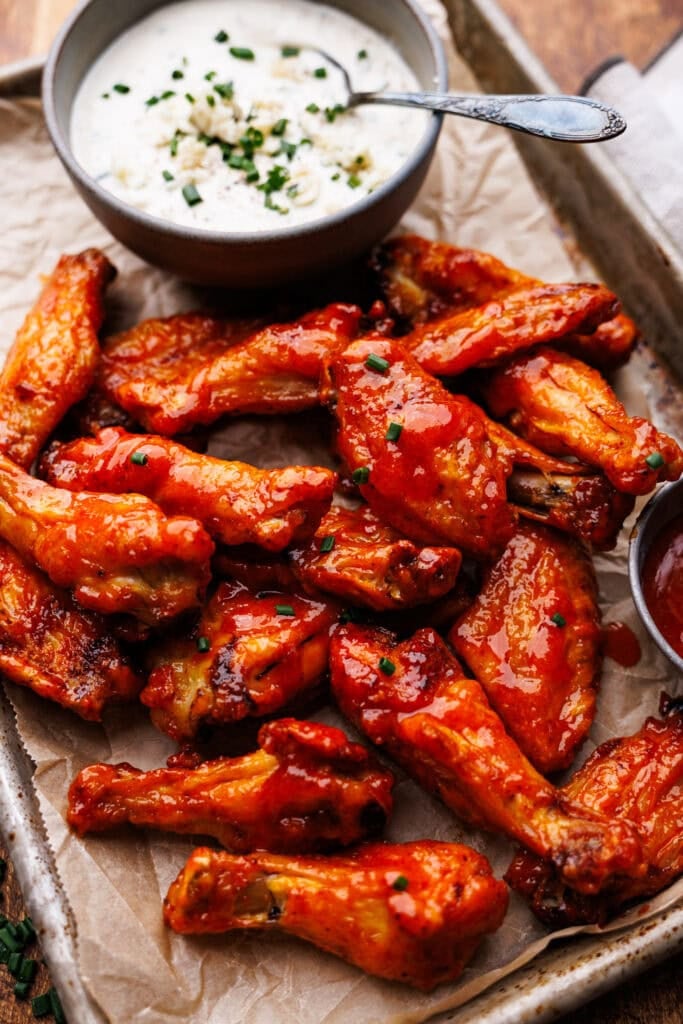 Buffalo chicken wings on a metal tray with blue cheese dip